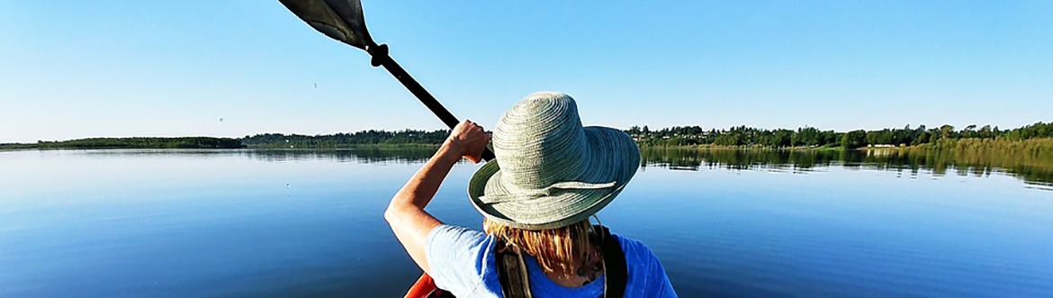 woman kayaking in a large lake